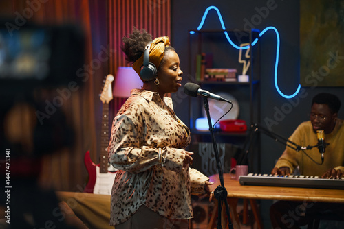 Photography African American performer singing song during podcast in studio