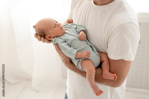 a sleeping newborn baby in daddy's arms, a baby sleeping sweetly at dad's, a healthy baby sleep, parental love and care, dad on maternity leave