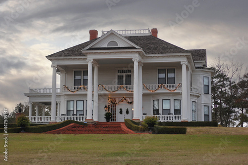 Historic Antebellum Home With Christmas Decorations at Sunset in Rural TX