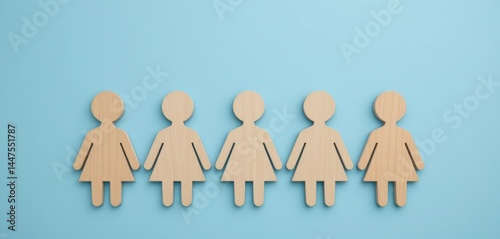 five wooden people, one replaced with dotted outline only, on solid baby blue background

