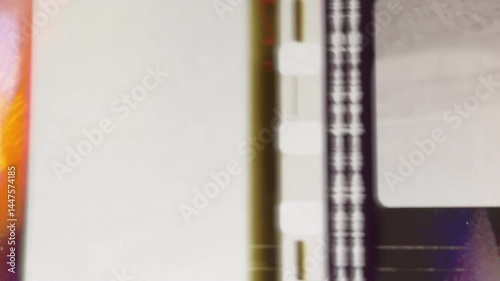 Super 8 film reel rotating, showing film damage and artifacts