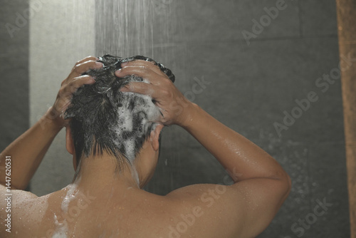 A man washes his hair with anti-dandruff shampoo. photo