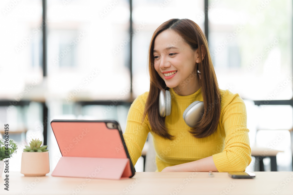 Smiling Woman Using Tablet at Desk Smiling Woman Using Tablet at Desk