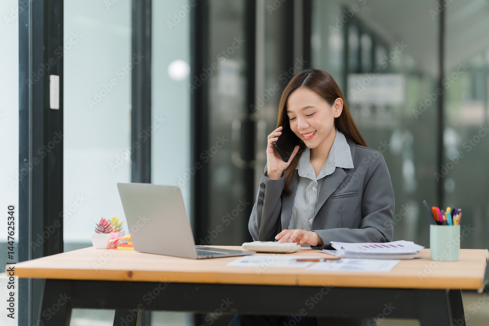 Smiling Businesswoman on Phone at Desk