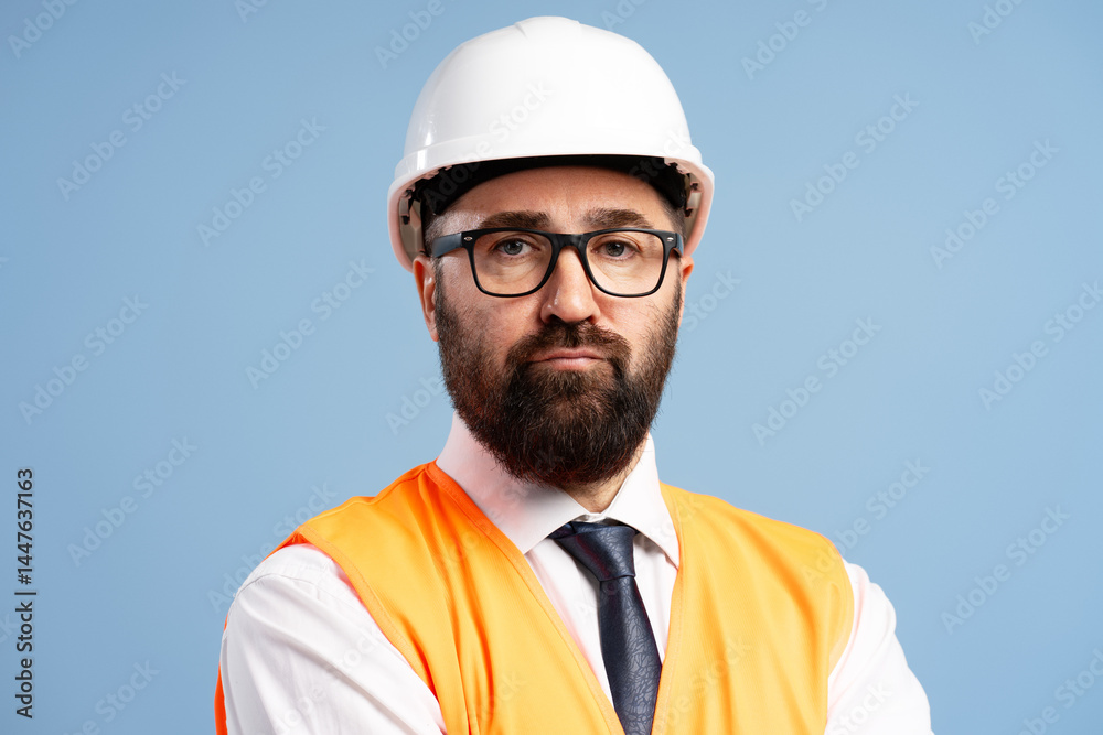 Serious engineer wearing hardhat and high visibility vest posing with crossed arms Serious engineer wearing hardhat and high visibility vest posing with crossed arms