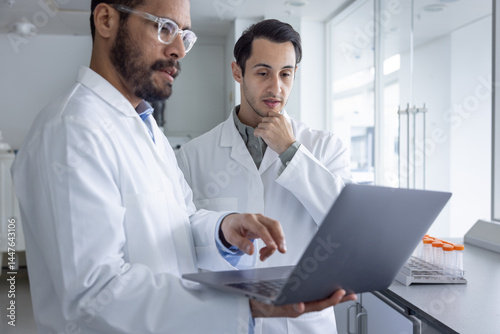 Scientists Colorating Over a Laptop in a 