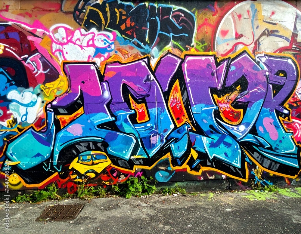 Obraz premium Vibrant graffiti art on a brick wall. Colorful letters and abstract designs.