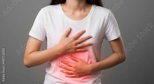 Wallpaper Mural Young Woman Holding Her Stomach with Red Glow on Gray Background Suffering from Pain Torontodigital.ca