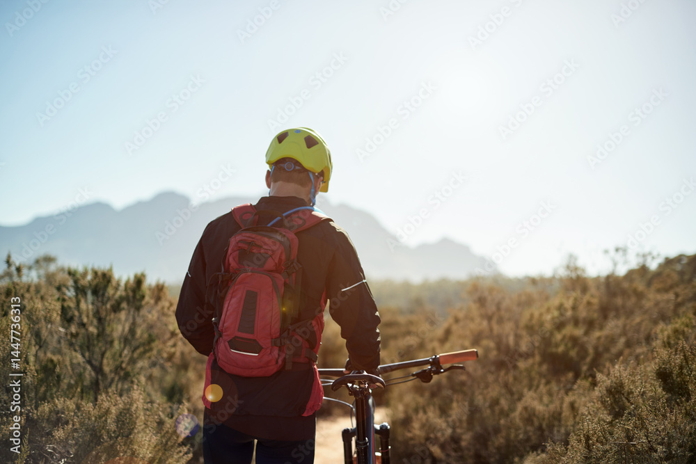 Man, walking or bike in nature for fitness, journey or travel break on trail. Back, tired athlete or bicycle on mountain path for morning workout, explore track or trekking with sky space in Germany