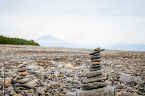 Rock stacking on Miho no Matsubara beach with mt Fuji