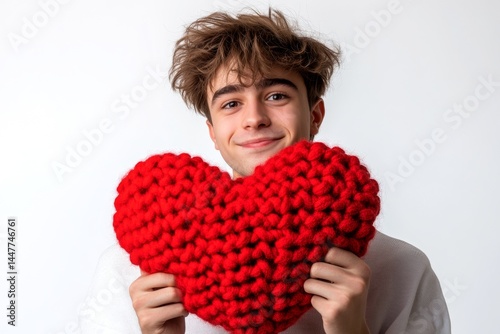 Obraz na płótnie Isolated white young man on pure white background with knitted heart in hands. Cute Valentine's Day greeting. Professional studio snapshot, copyspace. w salonie