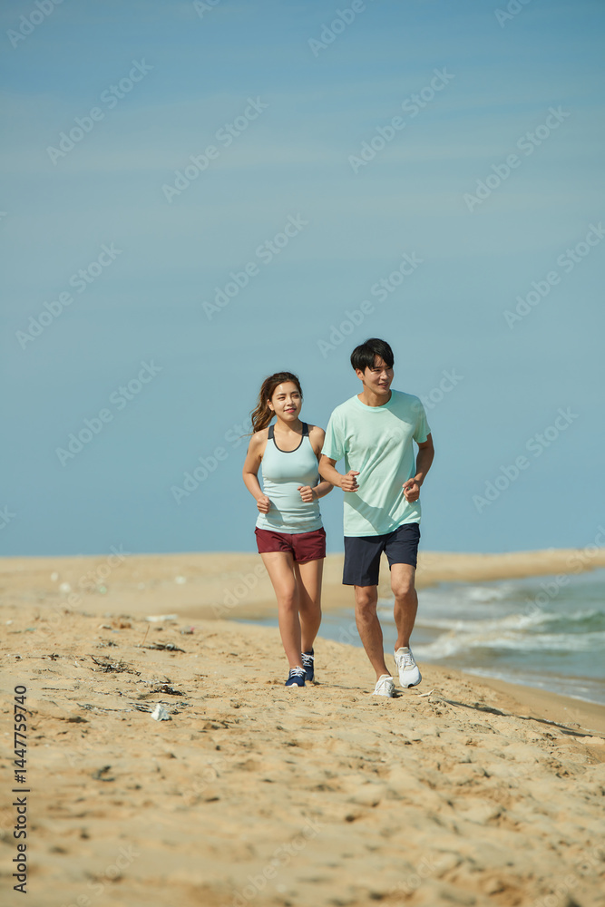 Young Couple Jogging on Sandy Beach Young Couple Jogging on Sandy Beach