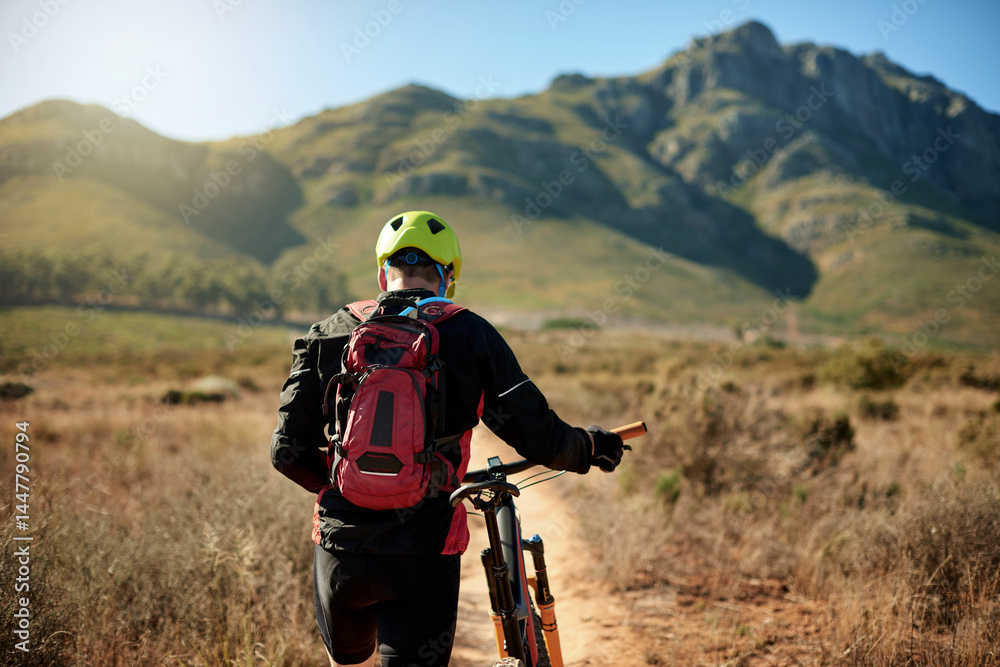 Man, tired and walking on mountain with bike, journey and travel with flat tire on trail. Back, athlete and bicycle on nature path for explore track, backpacking adventure and exercise in Australia Man, tired and walking on mountain with bike, journey and travel with flat tire on trail. Back, athlete and bicycle on nature path for explore track, backpacking adventure and exercise in Australia
