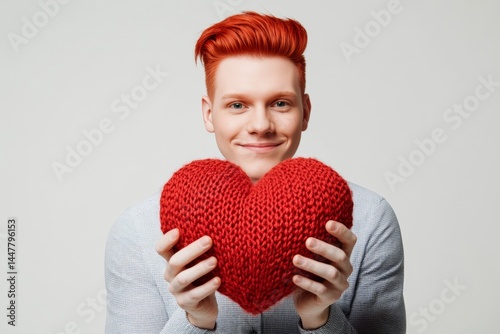 Obraz na płótnie Professional studio visual, copy space. Cute Valentine's Day greeting. Isolated white adult man on pure white background with knitted heart in hands. w salonie