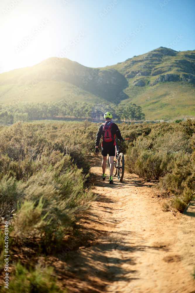 Back, nature and man walking by bicycle for fitness, journey and tired on outdoor adventure. Athlete, bike and travel on mountain path for exercise break, wellness and catching breath for sports Back, nature and man walking by bicycle for fitness, journey and tired on outdoor adventure. Athlete, bike and travel on mountain path for exercise break, wellness and catching breath for sports