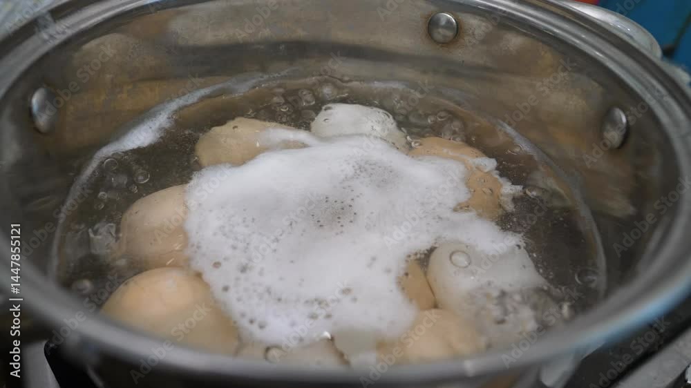 Close-up. Chicken eggs in a saucepan are boiled on a gas stove. Cooking chicken eggs. Slow motion. Close-up. Chicken eggs in a saucepan are boiled on a gas stove. Cooking chicken eggs. Slow motion.