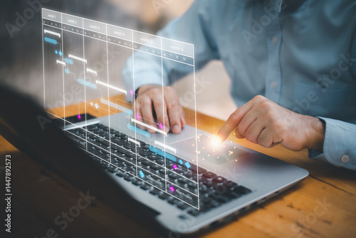 Scheduling activities with a planning software, Corporate strategy for finance, operations, sales, marketing. Project manager working with Gantt chart schedule to plan tasks and deliverables.