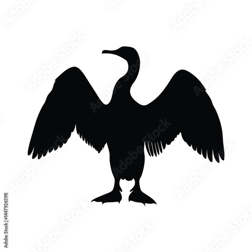Silhouette of a cormorant bird with wings spread, drying in the sun