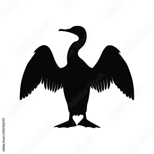 Silhouette of a cormorant bird with wings spread, drying in the sun
