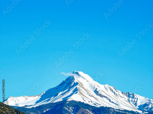 Obraz na płótnie A mountain covered in snow with a blue sky in the background. The mountain is tall and majestic, and the sky is clear and bright. Concept of awe and wonder at the beauty of nature w salonie