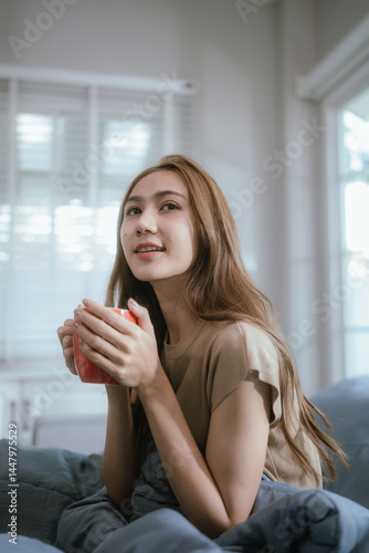 Attractive young woman stretching happily on a cozy bed in a sunlit bedroom, enjoying a peaceful and relaxing morning moment. Free Download Attractive young woman stretching happily on a cozy bed in a sunlit bedroom, enjoying a peaceful and relaxing morning moment. - GFXLoad