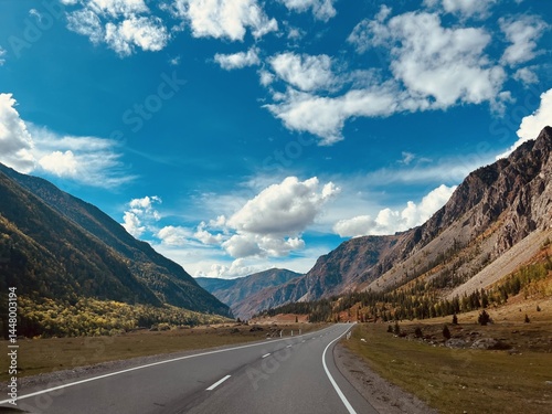 Scenic autumn landscape in altai mountains with open highway and dramatic sky for travel and adventure design