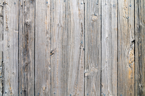Old weathered gray wood surface with irregularities and signs of aging.