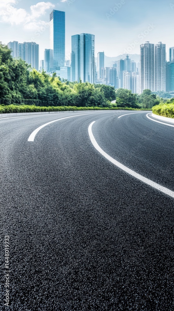 Obraz premium Urban road leading to modern city skyline with lush green trees under a bright blue sky creating a sense of adventure and travel destination