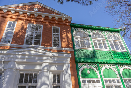 An old brick mansion with a wooden veranda, built in the 19th century. A large old house with a garden in the Caucasus. There is a literary museum in the old building. Renovated old mansion.