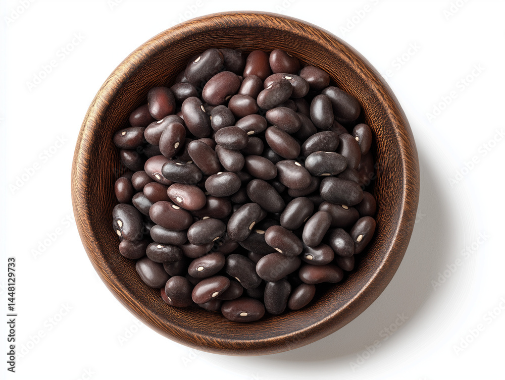 Fototapeta premium Black beans in a wooden bowl, isolated on white background, top view with clipping path.