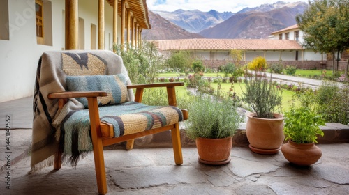 Cusco courtyard with woven chair  alpaca wool throw  potted herbs and open view to Andean mountain range