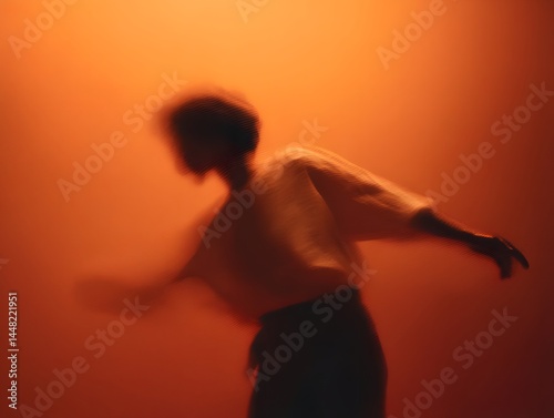 A dynamic silhouette of a person in motion against a vivid orange backdrop creating an artistic and abstract visual experience