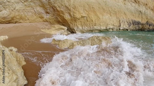 Powerful Waves Crashing Against Golden Shores of Praia de Benagil Portugal Static Shot