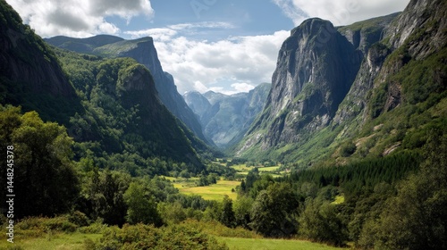 Majestic Mountain Valley Surrounded by Lush Greenery and Peaks