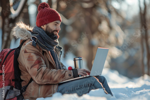 A dedicated freelancer embraces winter season as he diligently works outdoors with his laptop and thermos, finding inspiration and motivation in crisp air and serene surroundings    