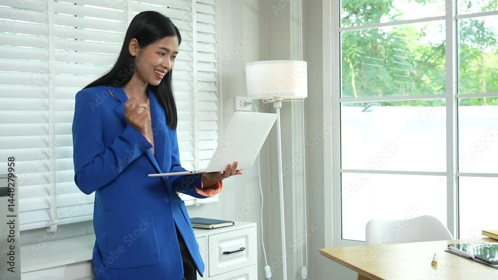 Asian businesswoman communicating with clients online using laptop in professional working environment. She is confident and articulate, demonstrating her skills in virtual communication. Asian businesswoman communicating with clients online using laptop in professional working environment. She is confident and articulate, demonstrating her skills in virtual communication.