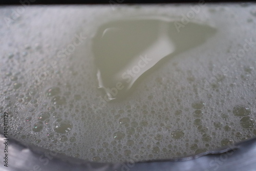 Closeup View of Dense Foamy White Liquid Bubbles with an area of thinner liquid