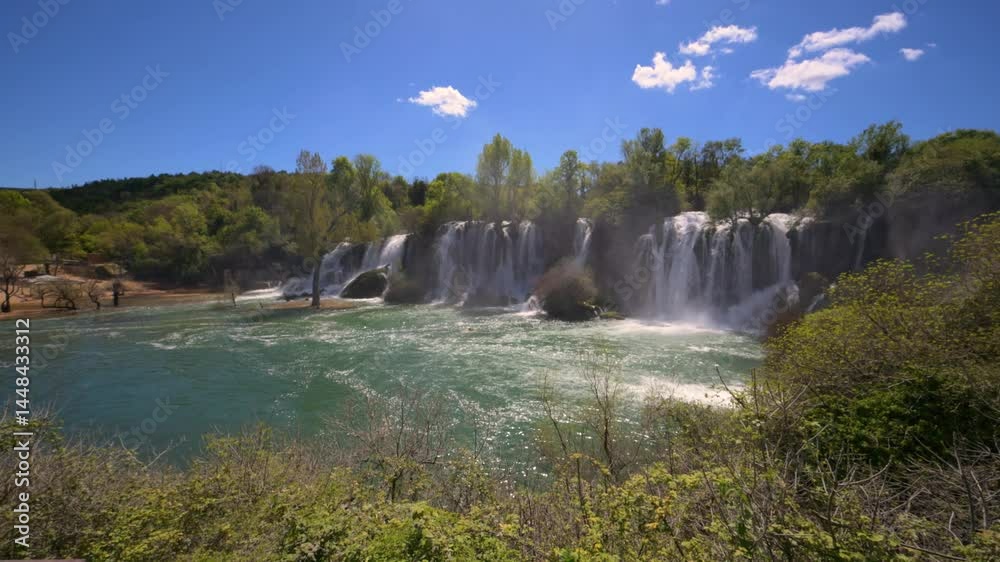 Kravica Waterfall in Bosnia and Herzegovina on a Sunny Day with beautiful emerald water and lush greenery Kravica Waterfall in Bosnia and Herzegovina on a Sunny Day with beautiful emerald water and lush greenery