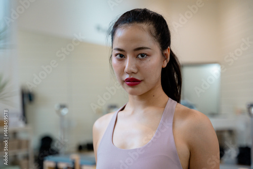 Free Download Young Asian Woman Posing in Pilates Studio - GFXLoad