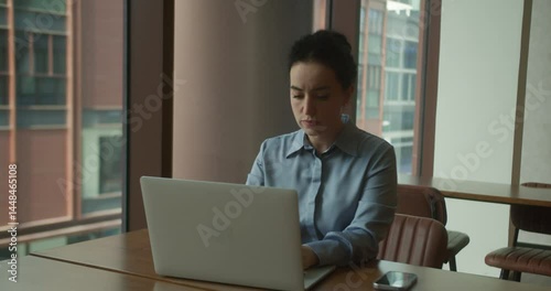 European woman working in office, tired office worker typing on laptop, work pile-up, last employee staying late at work, computer, smiling, good job, result, happy studying.