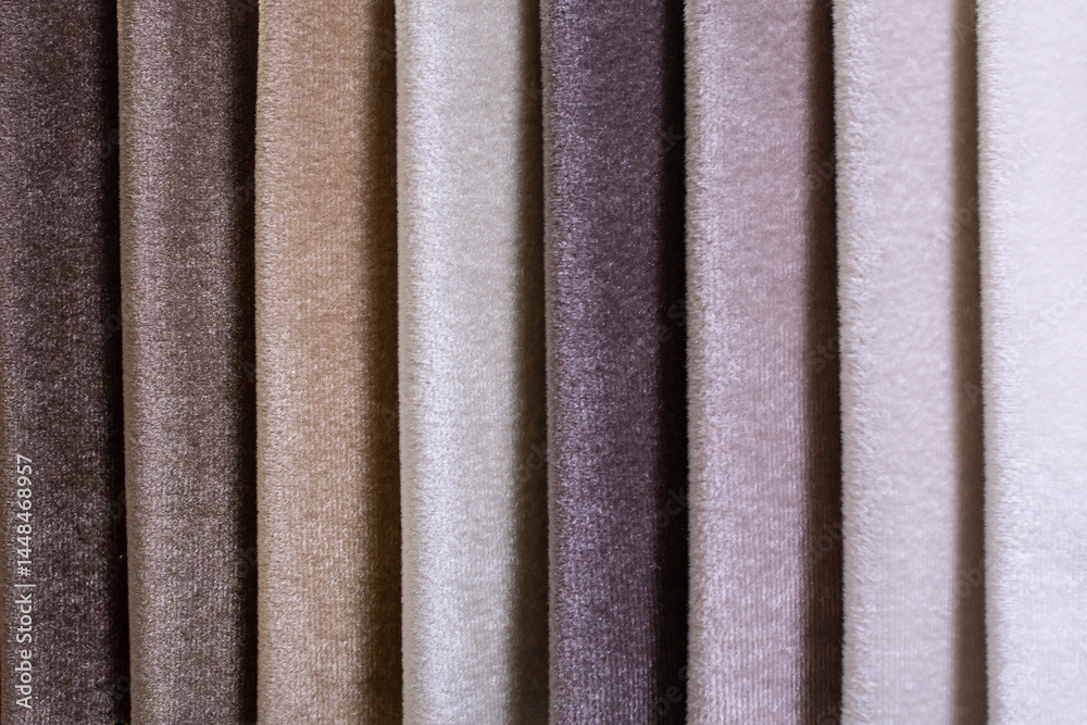Fototapeta premium Colorful samples of velvet upholstery fabrics close-up. gray shades swatches for furniture renovation