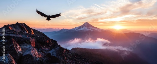 Majestic sunrise over mountain peaks with soaring bird