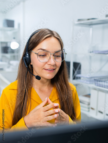 Woman Customer support, call center with headset working in office, consulting client, talking online, support service looking at computer screen at desk. Technical support CRM and telemarketing.