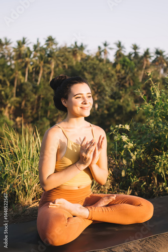 Obraz na płótnie Young woman meditating in Lotus Pose in nature w salonie