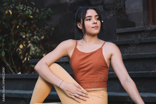 Obraz na płótnie Pretty caucasian female in active wear sitting in yoga pose satisfied with breathing and recreation, young 20s girl sitting in asana feel calmness and wellness reaching harmony during yoga practice w salonie