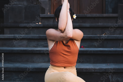 Obraz na płótnie Calm concentrated female in active wear reaching relaxation and inspiration on yoga practice, feeling zen and recreation, pensive woman practicing yoga outdoors enjoying recreating on training w salonie