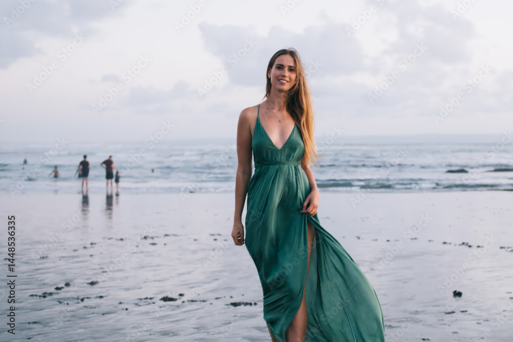 Slim woman walking along sea shore