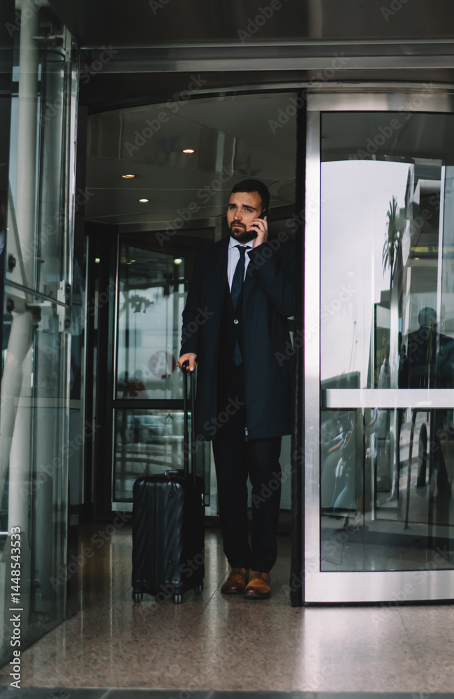 Confident businessman leaving airport