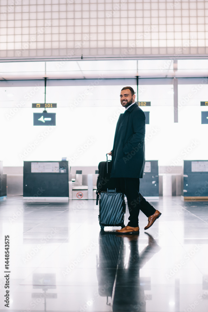 Man with suitcase in airport hallway