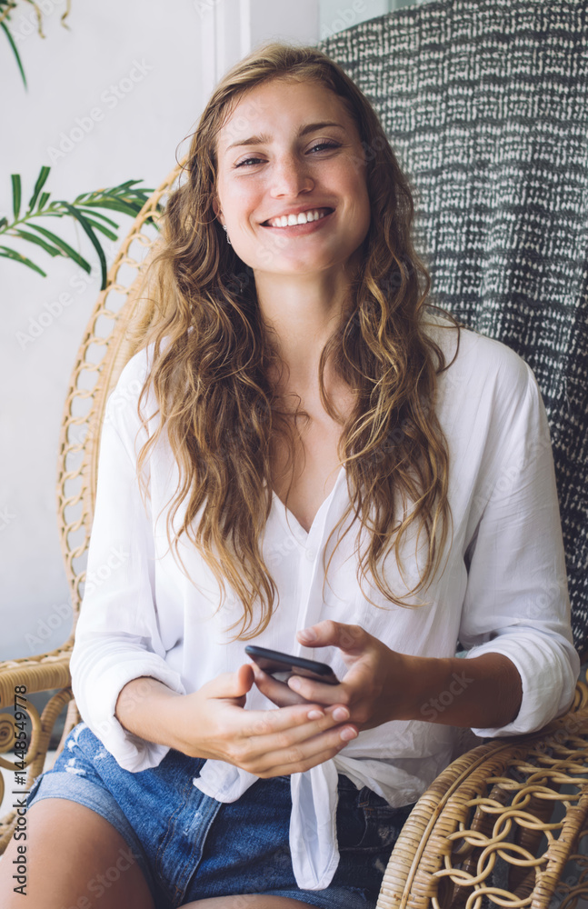 Laughing woman getting funny message on mobile phone